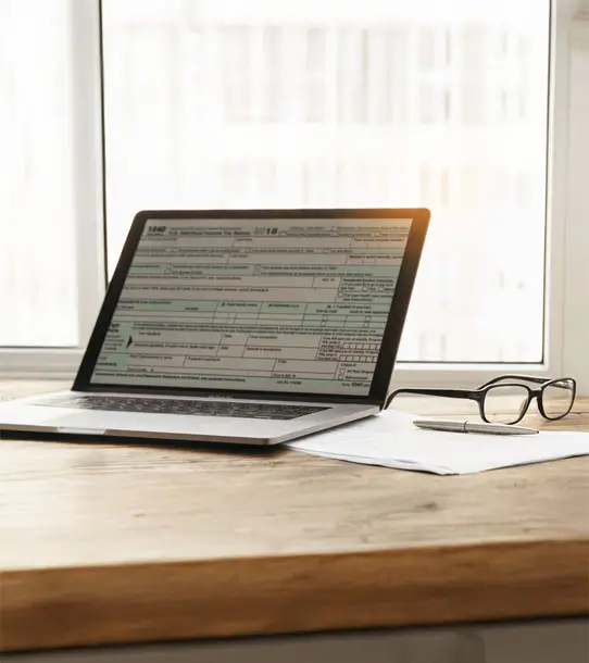 Laptop with form individual income tax returns.